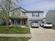 Inviting two-story home features a blend of siding and brick, covered porch, and a two car garage with driveway parking at 2348 Shadowbrook Dr, Plainfield, IN 46168