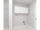 Laundry room features utility sink, wire shelving, and white cabinets at 2348 Shadowbrook Dr, Plainfield, IN 46168