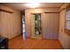 Wood-paneled living room featuring a doorway that leads to the utility closet with mechanicals at 2726 S Roena St, Indianapolis, IN 46241