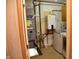 Utility room with water heater, furnace, washer, and dryer visible through the doorway at 2726 S Roena St, Indianapolis, IN 46241