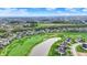 Overhead view of homes bordering a scenic golf course with mature trees and a tranquil pond feature at 284 Chatham Hills Blvd, Westfield, IN 46074