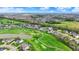 Aerial shot of a neighborhood and golf course community, showcasing luxury homes with well-maintained green spaces at 284 Chatham Hills Blvd, Westfield, IN 46074