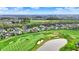 Aerial view featuring beautiful homes bordering a well-manicured golf course with a pond and expansive green spaces at 284 Chatham Hills Blvd, Westfield, IN 46074