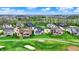 Aerial view showcasing luxurious homes situated alongside a lush green golf course in a serene community at 284 Chatham Hills Blvd, Westfield, IN 46074