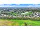 Aerial view of luxury golf course community homes surrounding a serene pond and lush fairways under a bright sky at 284 Chatham Hills Blvd, Westfield, IN 46074