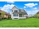 Large backyard features a patio, covered porch, and well manicured lawn at 284 Chatham Hills Blvd, Westfield, IN 46074
