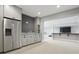 Basement bar area with stainless steel refrigerator, granite counters, and bar top seating at 284 Chatham Hills Blvd, Westfield, IN 46074