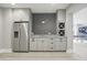 A basement bar features gray cabinets, granite countertops, and stainless steel appliances at 284 Chatham Hills Blvd, Westfield, IN 46074