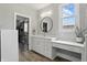 Bright bathroom with a vanity area, a large window, and an open door to the walk-in closet at 284 Chatham Hills Blvd, Westfield, IN 46074