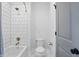 Bathroom featuring a tub with white subway tile surround and a modern toilet at 284 Chatham Hills Blvd, Westfield, IN 46074