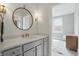 Bathroom vanity with white counters, decorative mirror and sconces with view to bedroom at 284 Chatham Hills Blvd, Westfield, IN 46074