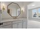 Bathroom vanity with white countertops, an octagonal mirror, and sconces at 284 Chatham Hills Blvd, Westfield, IN 46074