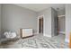 Bedroom with a rocking chair, dresser, and doorways for easy access to other rooms at 284 Chatham Hills Blvd, Westfield, IN 46074