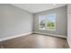 Serene bedroom with wood floors, neutral walls, and a window providing natural light and neighborhood views at 284 Chatham Hills Blvd, Westfield, IN 46074