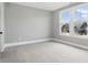Bright bedroom with neutral walls, carpet, and a large window overlooking the green outdoors at 284 Chatham Hills Blvd, Westfield, IN 46074