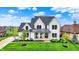 Stunning two-story white home with black trim, lush lawn, and inviting front porch at 284 Chatham Hills Blvd, Westfield, IN 46074