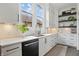Elegant kitchen with white cabinets, a dark faucet, and decorative shelving at 284 Chatham Hills Blvd, Westfield, IN 46074