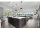 Spacious kitchen with large island, stainless appliances, and an open floor plan into the living room at 284 Chatham Hills Blvd, Westfield, IN 46074