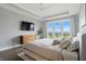 A spacious main bedroom featuring a tray ceiling, hardwood floors, a TV, and balcony access at 284 Chatham Hills Blvd, Westfield, IN 46074