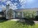 Backyard with concrete patio, mature evergreens and flowering bushes near sliding glass doors at 2904 Inverrary Ct, Indianapolis, IN 46234