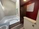 Bathroom featuring a soaking tub, glass block window and a separate shower with glass doors at 2904 Inverrary Ct, Indianapolis, IN 46234