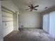 Cozy bedroom with a ceiling fan, built-in shelving, and neutral walls at 2904 Inverrary Ct, Indianapolis, IN 46234
