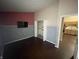 Bedroom featuring hard wood floors, two-tone accent walls, kitchen view, and a large closet at 2904 Inverrary Ct, Indianapolis, IN 46234