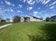 View of a home featuring a wood deck, grassy hill and beautiful blue sky with clouds at 2904 Inverrary Ct, Indianapolis, IN 46234