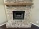 Close-up of a brick fireplace with a wooden mantel at 2904 Inverrary Ct, Indianapolis, IN 46234
