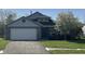 Charming home with a well-manicured lawn, a two-car garage, and attractive brick and siding accents at 2904 Inverrary Ct, Indianapolis, IN 46234