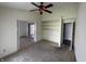 Open living room featuring a ceiling fan, neutral walls, and built-in shelving at 2904 Inverrary Ct, Indianapolis, IN 46234