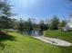 This backyard features a serene pond view with trees and shrubs surrounding the water at 2904 Inverrary Ct, Indianapolis, IN 46234