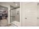 Modern bathroom showcases a tiled walk-in shower with glass doors, complementing the clean, white door at 3235 Myrtle Dr, Lapel, IN 46051