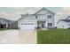 Charming two-story home with a well-manicured lawn, attached two-car garage, and a welcoming front porch at 3235 Myrtle Dr, Lapel, IN 46051