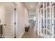 Hallway with wood-look floors leads to the home's living spaces, plus a door to a powder room at 3235 Myrtle Dr, Lapel, IN 46051