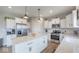 Spacious kitchen with a large center island, stainless steel appliances, and white subway tile backsplash at 3235 Myrtle Dr, Lapel, IN 46051
