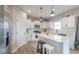 This beautifully designed kitchen includes an island with seating, modern appliances, and bright white cabinets at 3235 Myrtle Dr, Lapel, IN 46051