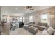Open living room with hardwood flooring, ceiling fan and lots of natural light overlooking the kitchen at 3235 Myrtle Dr, Lapel, IN 46051