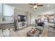 Open-concept living room features stairs, a fireplace, ceiling fan, and seamless flow to the kitchen and dining area at 3235 Myrtle Dr, Lapel, IN 46051