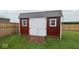 Attractive storage shed with double doors and a ramp, set against a green lawn and fence at 3235 Myrtle Dr, Lapel, IN 46051
