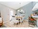 Bright dining room with white wooden table set, and light fixture at 324 Palmyra Dr, Indianapolis, IN 46239