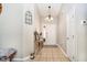 Inviting foyer with a tiled floor, console table, chandelier, and white door at 324 Palmyra Dr, Indianapolis, IN 46239