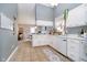 Open kitchen with white cabinets and tile flooring, flowing into a dining area at 324 Palmyra Dr, Indianapolis, IN 46239