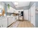 Well-lit kitchen features white cabinets, stainless steel appliances and vaulted ceiling at 324 Palmyra Dr, Indianapolis, IN 46239