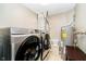 Laundry room with modern washer, dryer, and water heater at 324 Palmyra Dr, Indianapolis, IN 46239