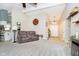 Spacious living room featuring neutral tones, plush carpeting, and a decorative clock at 324 Palmyra Dr, Indianapolis, IN 46239