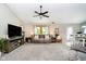 Cozy living room with plush carpeting, a ceiling fan, and dining area off to the side at 324 Palmyra Dr, Indianapolis, IN 46239