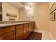Bathroom featuring double vanity with granite countertop and wood cabinets at 333 Massachusetts Ave # 204, Indianapolis, IN 46204