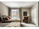 Cozy bedroom showcases two twin beds, an armchair, and decor art providing a charming and relaxing atmosphere at 333 Massachusetts Ave # 204, Indianapolis, IN 46204