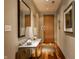 Inviting hallway featuring hardwood floors, decorative lighting, and stylish decor accents at 333 Massachusetts Ave # 204, Indianapolis, IN 46204